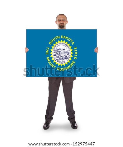 Smiling businessman holding a big card, flag of South Dakota, isolated on white