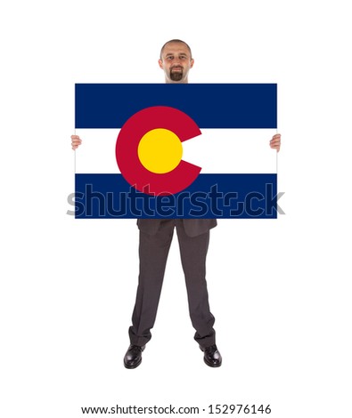 Smiling businessman holding a big card, flag of Colorado, isolated on white