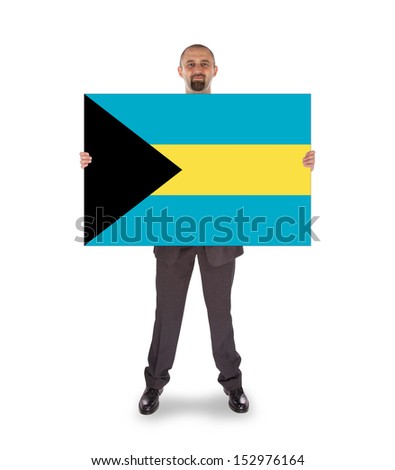 Businessman holding a big card, flag of the Bahamas, isolated on white