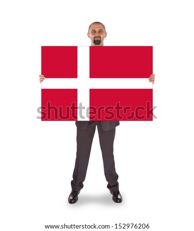 Smiling businessman holding a big card, flag of Denmark, isolated on white