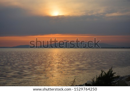 Soft sea, sunset and clouds