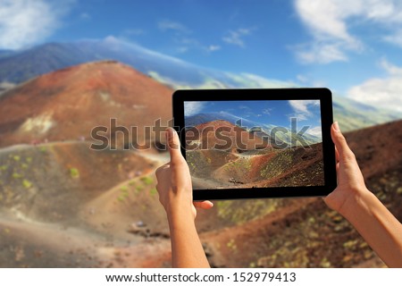 Girl taking pictures on a tablet, Etna volcano, Sicily