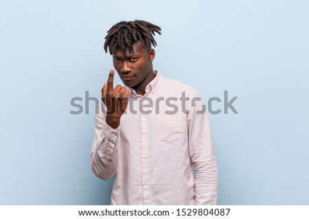 Young business african black man pointing with finger at you as if inviting come closer.