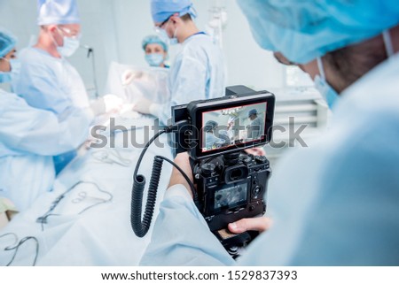 The videographer shoot the surgeon and assistants in the operating room with surgical equipment. Medical background Royalty-Free Stock Photo #1529837393