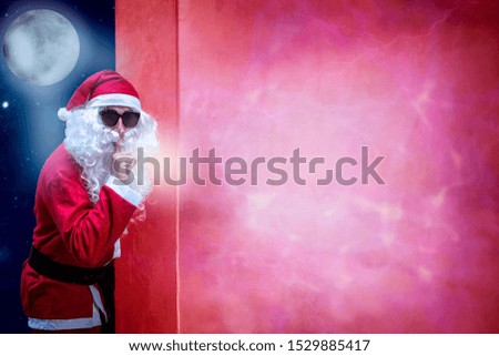 Santa Claus pointing in blank sign.Background moon
