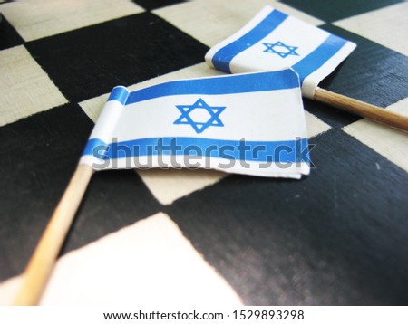 two Israeli flags lie on a chessboard Royalty-Free Stock Photo #1529893298