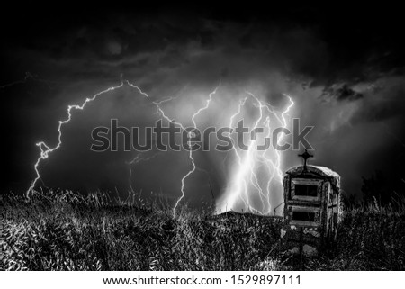 Lightning and moon in dramatic landscape