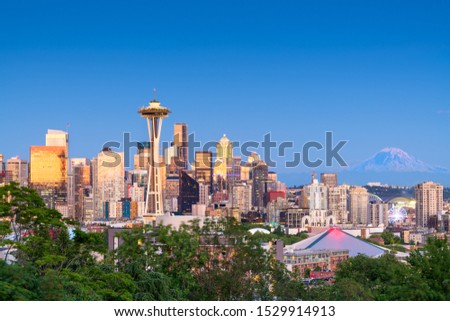 Seattle, Washington, USA downtown skyline at night with Mt. Rainier.