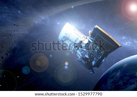 Space telescope above the earth, with reflection of the sun. Elements of this image were furnished by NASA