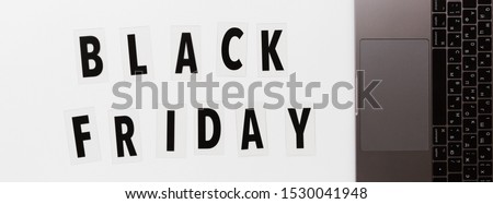 Creative promotion composition Black friday text and laptop on white background. Flat lay, top view, overhead, mockup, template. Minimal abstract background. Online shopping, sale, promo. Web banner
