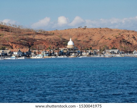 View of the fishing village called Papagarang with blue ocean and coral reef located in Komodo National Part, East Nusa Tenggara, Flores, Indonesia.