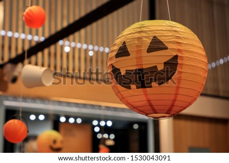 Halloween pumpkin lantern hanging for decorated in shop in Halloween festival season.