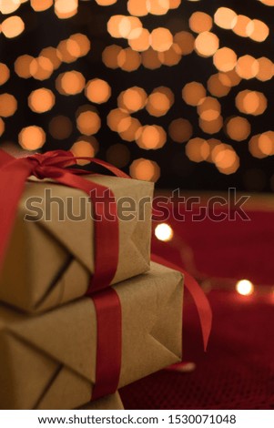 Gift box against bokeh background for holiday greeting card.