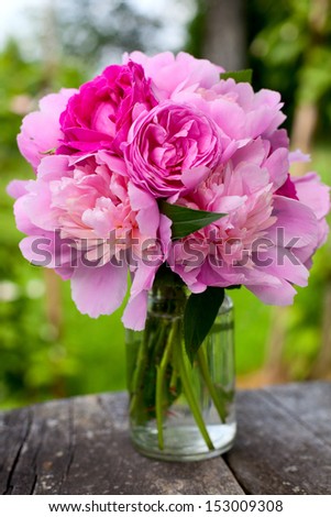 peony and rose bouquet on wooden surface