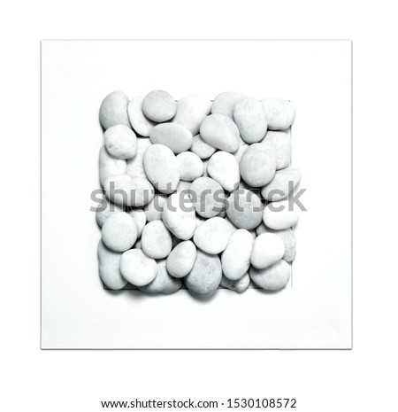 Set of pebble stones in picture frame isolated on white background.