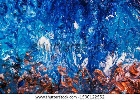 Textured abstract art background. Blue and brown wet acrylic paint mix. Sea waves at sandy beach effect.