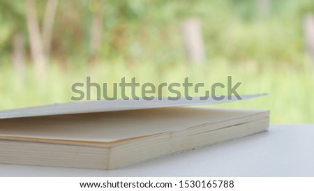Close up book in reading concetp on green background.
