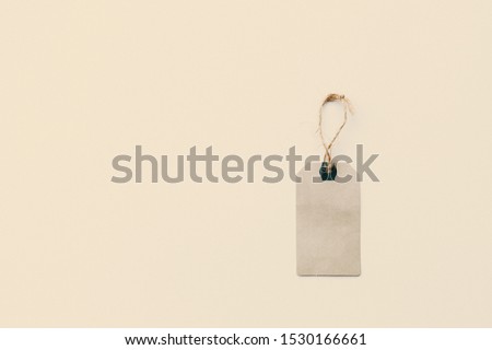 Paper label with rope on white background. Sale in modern design. Minimal concept. Flat lay, top view, mockup, template, copy space for text, overhead