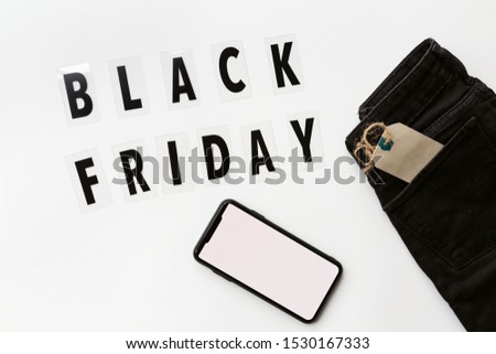 Creative promotion composition Black friday text and jeans on white background. Flat lay, top view, overhead, mockup, template. Minimal abstract background. Online shopping, sale, promo. Web banner