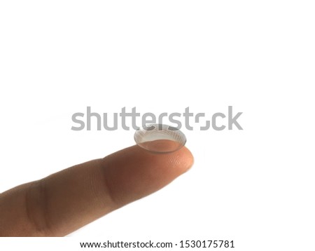 Closeup contact lens. Brown contact len is on a finger.
