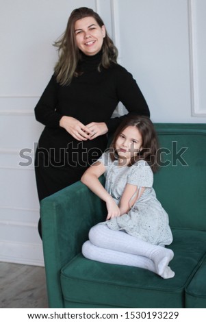 Mom and daughter spend time together. A mother's love and care. the child embraces and loves his mother. Carefree and joyful morning. Warm and tender relationship