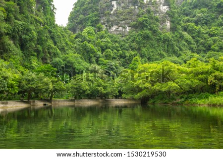 Vietnam natural heritage of Trang An landscape complex, spectacular landscape of limestone peaks permeated with valleys, caves and rivers. Tourists can use kayak or small boat for the excursion.