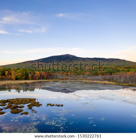 Aerial view of Mt Monadnock fall foliage over pond with reflection on water surface Royalty-Free Stock Photo #1530222761