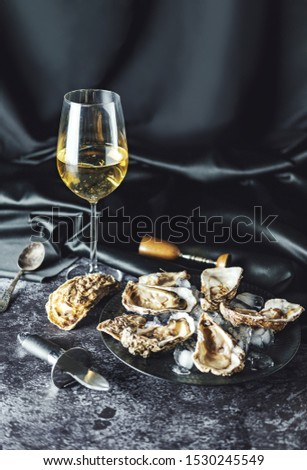 Oysters served with sparkling wine. Royalty-Free Stock Photo #1530245549