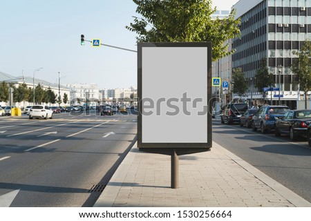 Vertical billboard for commercial advertisements standing by busy highway in city center. Digital solutions for promotional campaigns, great way to draw attention to product and service ads outdoors.