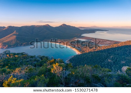 Sunrise nature landscape of beautiful ocean bay, lagoon and mountains. Wineglass bay in Tasmania, Australia Royalty-Free Stock Photo #1530271478