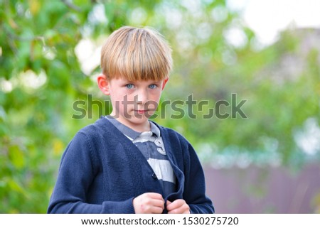 The delinquent boy was punished and looks in camera with sadness in his eyes. Royalty-Free Stock Photo #1530275720