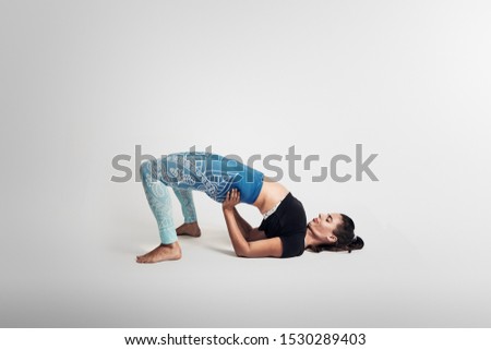  Yoga bridge pose, woman on white background, studio photos