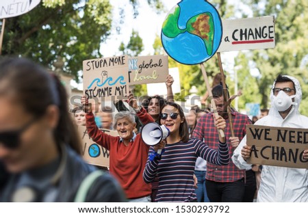 People with placards and amplifier on global strike for climate change.