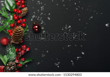 New Year tree balls and hoarfrost berries top view background. Christmas decorations. Fir branches and festive toys. Decorative backdrop with copyspace. Winter holidays composition