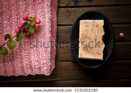 Organic natural hand made soap with calendula petals, cold process, with rose towel and rose berries, spa concept, home spa , sauna concept, relax and body care, spa treatment hoemade, close up