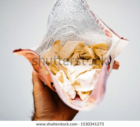 Man hand holding package of frozen Jiaozi a Chinese dumpling, commonly eaten in China and other parts of East Asia