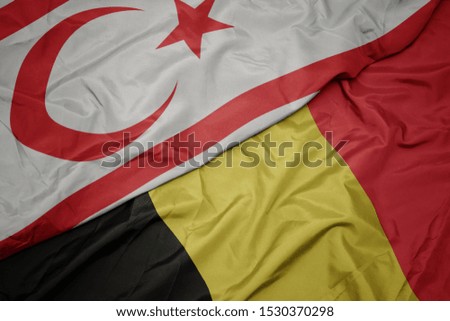 waving colorful flag of belgium and national flag of northern cyprus. macro