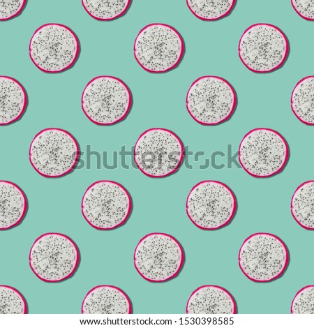 Seamless pattern of sliced pitaya on neo mint green color background. Minimal, flat lay, food texture. 