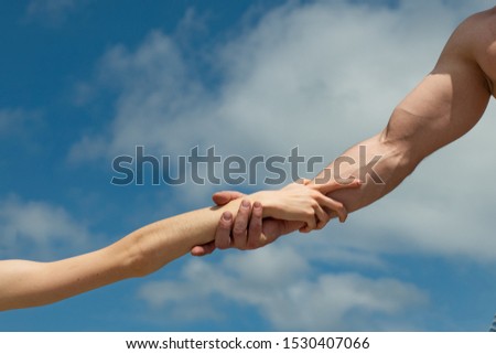 Hands. Female and male hand against the sky. Help and support. Together concept.