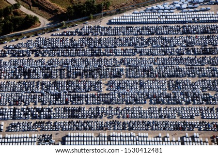 aerial view of parking cars at the automobile production facility. 