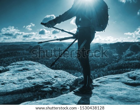 Photographer come to location to taking pictures with camera. Nature landscape photographer with photo equipment on rock.