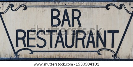 Old faded vintage bar restaurant sign