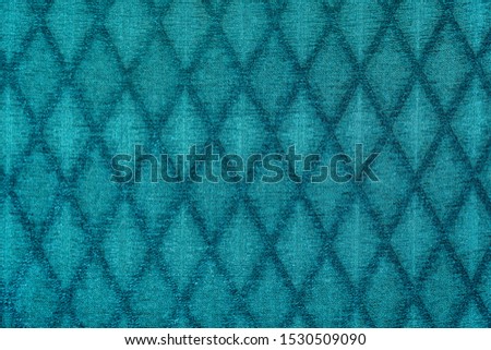 Texture of green fabric with diamond or rombic pattern