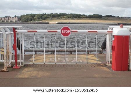 Stop sign barrier to prevent people, cars or ehicles from entering a river from a wharf or quayside