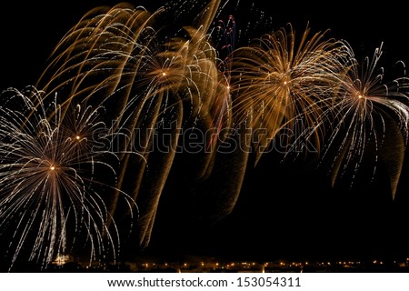 Colorful golden yellow fireworks with village silhouette in dark night background in Malta, fireworks explosion in dark sky background, Malta fireworks festival, 4 of July, explode, August 15