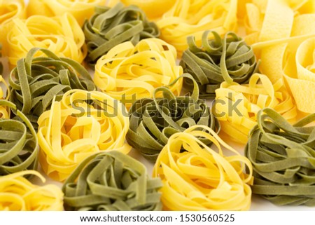 The heap of tagliatelle pasta closeup picture.