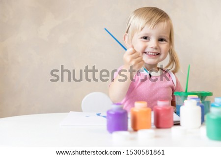 Cute Baby Girl Draws Tassel and Paints. Childhood. Art