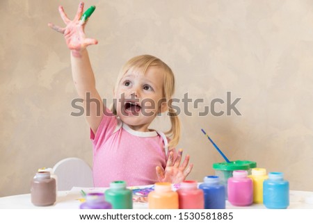 Little Child Draws Painted Hands in Paint. Painting. Development and Training