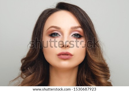 Woman with Long Healthy Colorful Ombre Wavy Hair and Perfect Make up. Close Up of Hairstyle. Care, Hair, Cosmetics Products