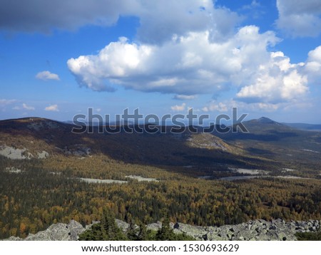 Clouds over autumn mountain valley